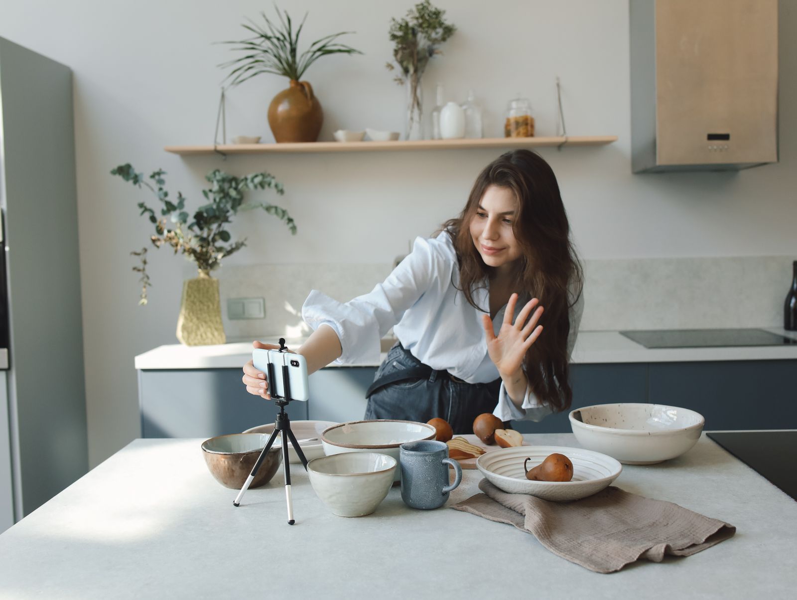 A creator recording a video on a smartphone mounted on a tripod